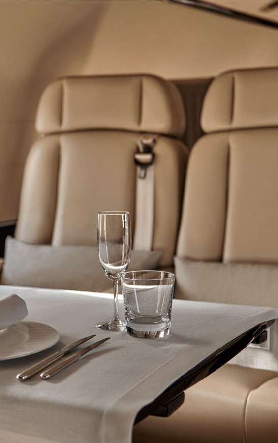 Elegant fine dining table setting inside a private jet cabin — VIP inflight catering by Inflight Gourmet